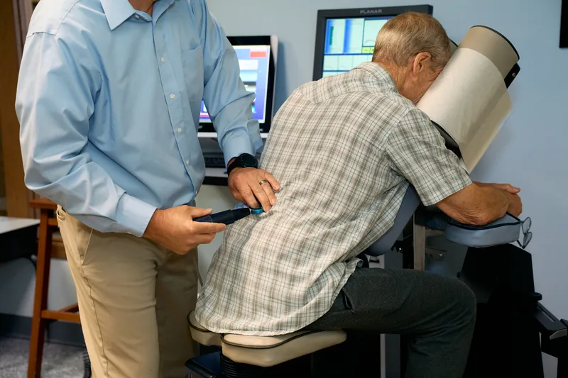 An older patient receiving a gentle, computer-guided adjustment